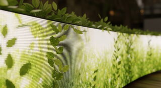 Die Produkte von Unilumin sind emissionsarm Ein gebogener Bildschirm, welcher eine grüne Weltkugel zeigt, steht auf einem bemoosten Stein in der Natur. Das Bild stellt durch seine abgebildete grüne Natur den Zusammenhang von emissionsarmer und umweltschützender Produktion in Zusammenhang.